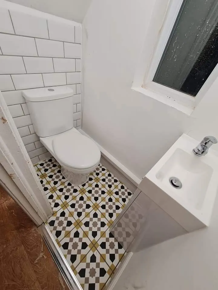 Renovated cloakroom with compact fitted sanitaryware and tiled detailing