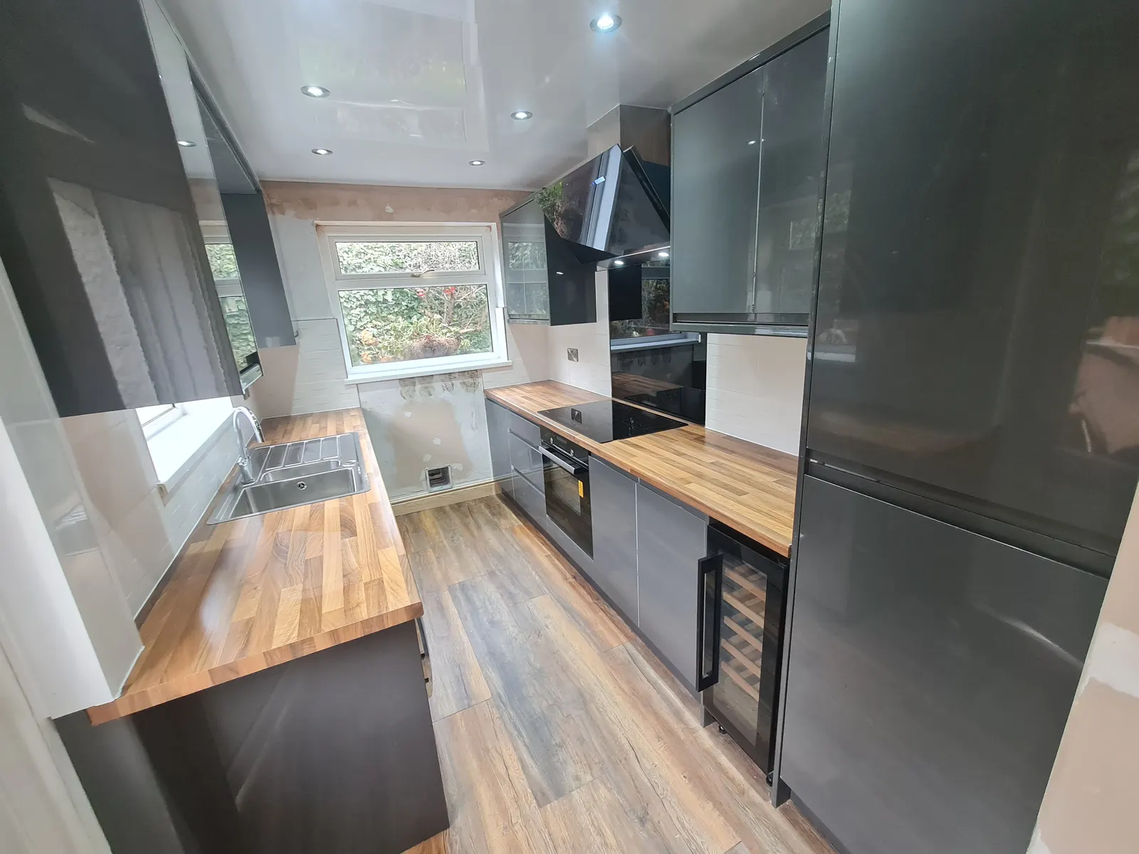 Dark charcoal kitchen cabinetry and finished work surfaces