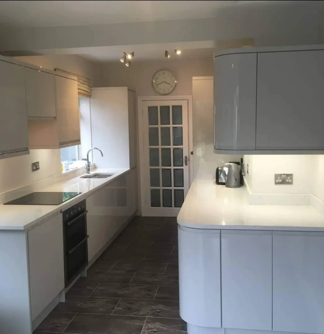 Light-toned kitchen renovation with finished cupboards and counters