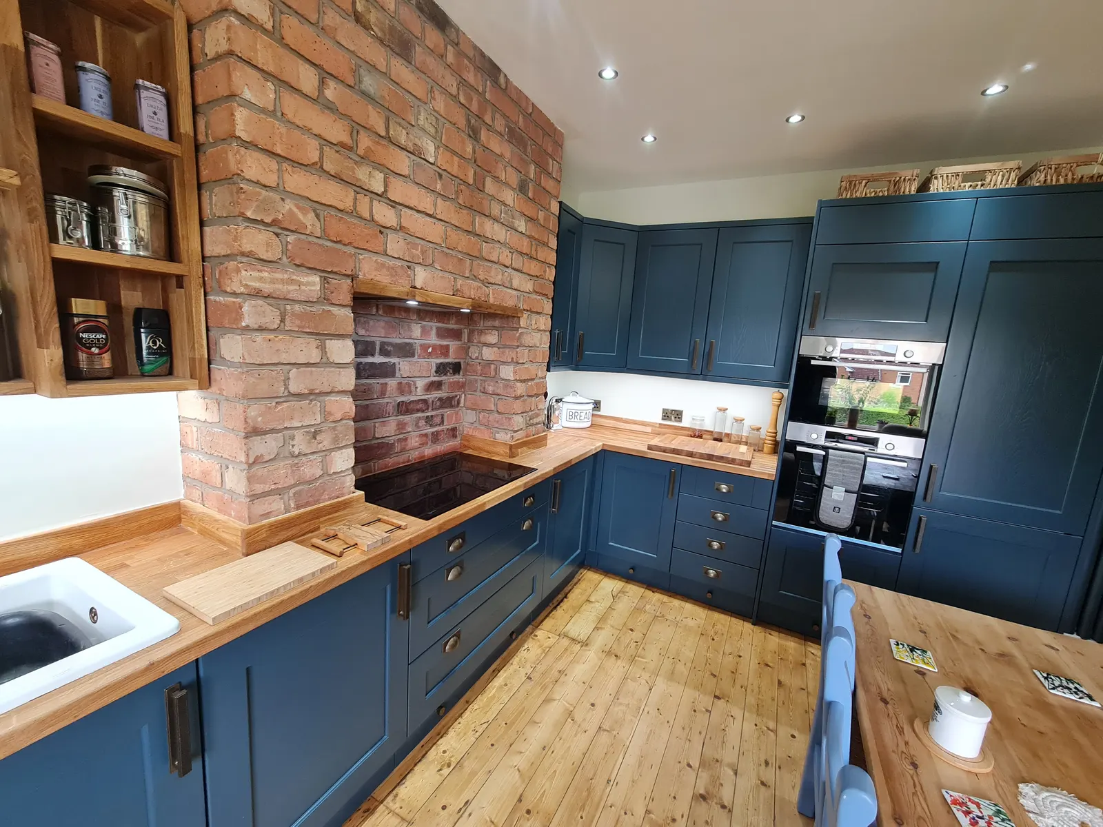 Navy fitted kitchen with carefully aligned cabinetry and fixtures